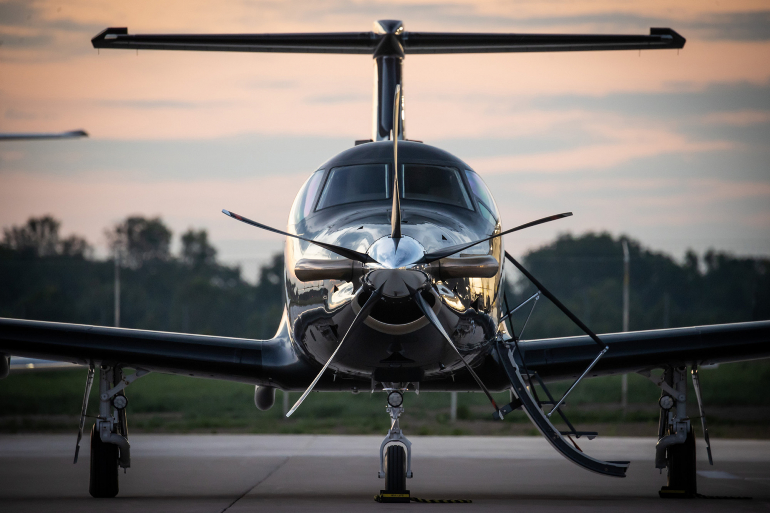 Otter jet front of propeller standing on runway in evening